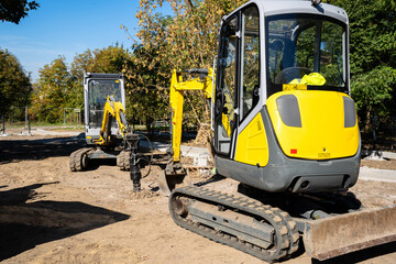 Two mini-excavators are working at the construction site © Олеся Матвеева