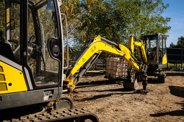 Two mini-excavators are working at the construction site © Олеся Матвеева