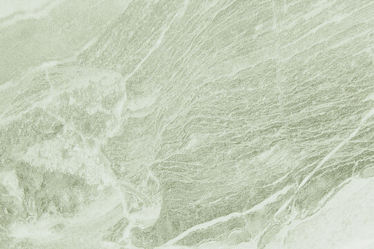 Full frame view of sage green polished marble stone slab surface with natural veins for luxury kitchen countertop or abstract background photo