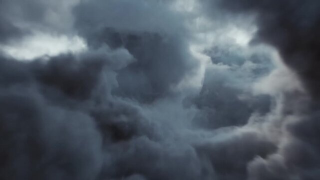 Dark storm clouds billow and swirl around a bright opening in an overcast sky