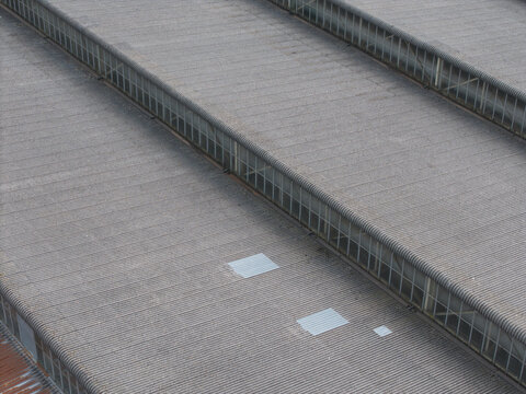 Aerial view of the industrial factory roofs in Bayswater North featuring corrugated metal surfaces and rows of clerestory windows in Melbourne, Victoria, Australia.