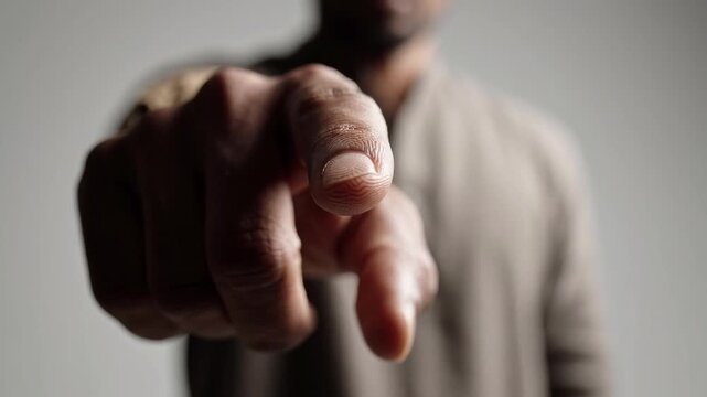Man pointing directly at camera in close-up video. Direct address and personal responsibility concept. Call to action, choice and decision making. Business communication.