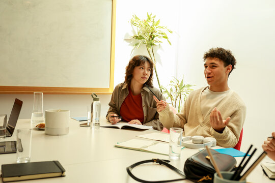 Group Discusses Ideas in a Bright Meeting Room