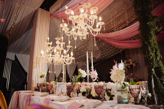 An elegantly decorated table at an event, featuring a floral centerpiece.