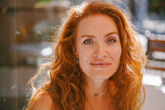Sunlit portrait of a red-haired woman