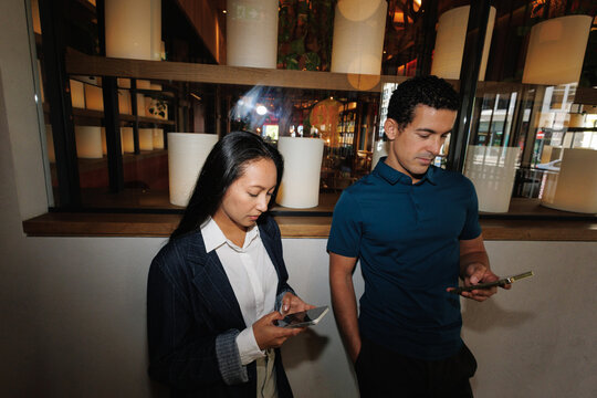 Couple ignoring each other using smartphones