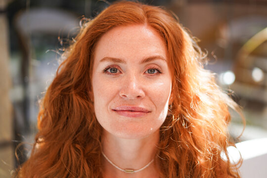 Radiant young woman with copper hair