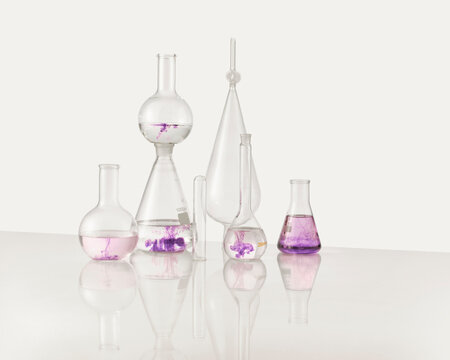 A collection of laboratory glassware with purple liquid