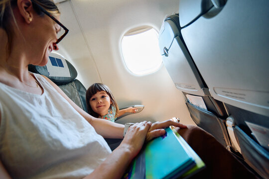 Mother and Daughter enjoying a Flight Airplane
