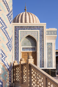 Ornate facade of Hazrat Khizr mosque in Samarkand featuring intricate tilework and a ribbed dome against a clear blue sky. Ideal for travel publications, cultural heritage content, and architectural.