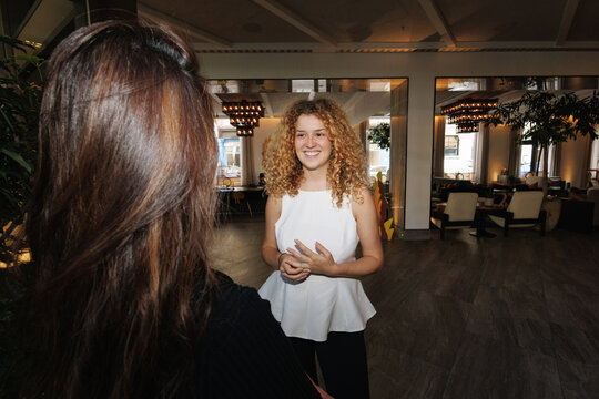 Two women having a friendly conversation in a modern lounge