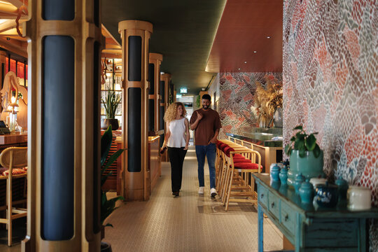 Couple walking through a modern hotel or restaurant lobby