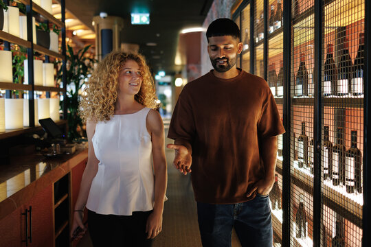 Couple walking and talking in restaurant wine cellar