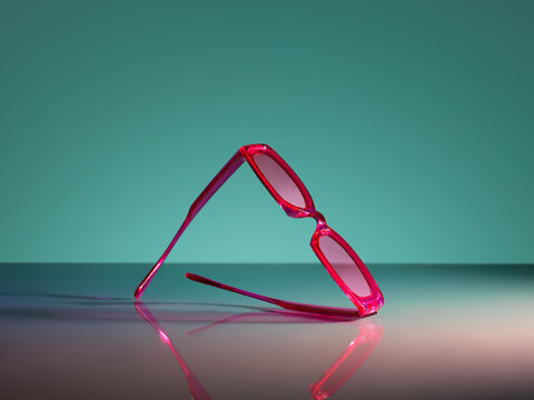 Vibrant pink sunglasses with a glossy finish
