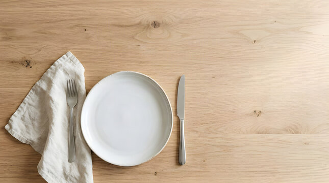 Empty white plate with silver fork and knife on rustic wooden dining table dinnerware tableware silverware breakfast restaurant interior appetite