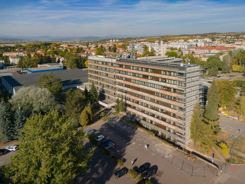 Aerial view of the Faculty of Technology at the Technical University in Zvolen, featuring a building with scaffolding and parking areas in Zvolen, Banskobystricky kraj, Slovakia.