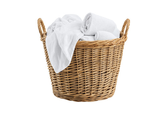 Woven wicker laundry basket filled with clean folded white bath towels and linens isolated