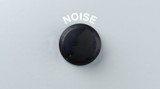 Minimalist black rotary control knob with noise text label on clean light gray background representing sound reduction and volume adjustment