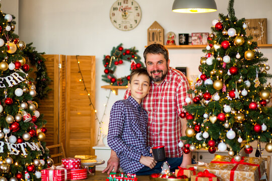 Happy family with a baby celebrating Christmas at home, enjoying cozy holiday moments together near a decorated Christmas tree in a warm festive atmosphere