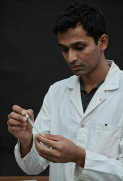 Medical research and clinical testing, scientist in lab coat using a pipette for chemical analysis in a laboratory setting with focus and precision