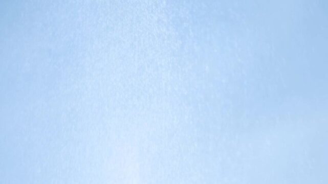Light blue abstract texture remains still with soft mottled patterns across a blank background