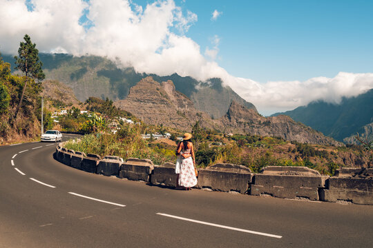 Mother and Daughter Embracing Beside a Mountain Road Overlooking Cilaos Village and Cirque de Cilaos at Sunset on Reunion Island