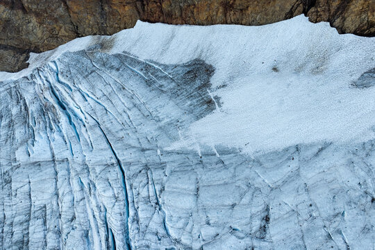 Aerial View of Chilliwack Glacier Ice and Snow Against Rocky Mountain Cliffs in BC, Canada