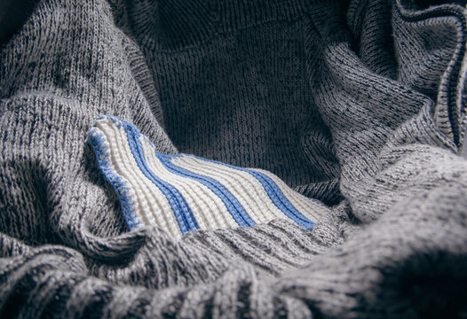 Cozy winter grey and white knitted wool fabric texture background
