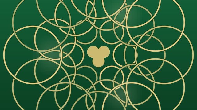Interlocking gold rings turning on deep green