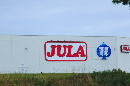 Kristiansund, Norway - September 15, 2026. Jula and Sparkjop retail store logos on a white shopping center facade