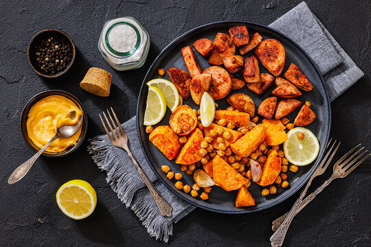 sliced sausage with sweet potato wedges, chickpeas