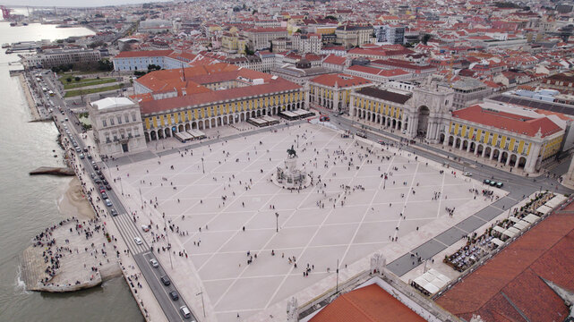 Aerial view of Praca do Comercio with its large open square, the statue of King Jose I, surrounding yellow historic buildings, and the Tagus River waterfront in Lisbon, Lisbon, Portugal.