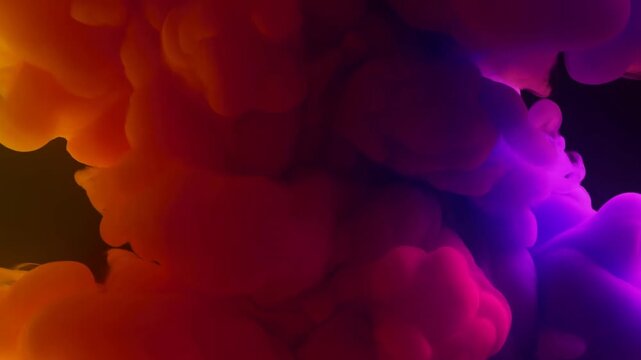 Colored ink clouds billow and spread through dark water in orange, red, and violet