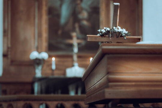 Wooden Coffin with Decorated Cross in Church During Christian Funeral Ceremony