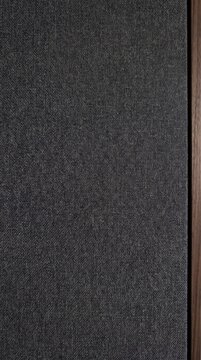 Subtle charcoal woven acoustic fabric panel with walnut wood edge, clean minimal background