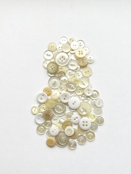 snowman object made from button collage, daruma doll collage made with buttons, button art, white daruma-shaped object, decorative illustration made with white buttons