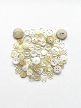 bear-shaped object made from button collage, bear face made with buttons, decorative illustration made with white buttons