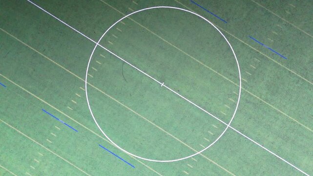 Top down view of center circle markings on artificial green turf sports field
