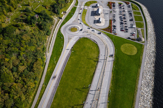 Aerial view of the Ryfast Tunnel entrance and bus terminal, featuring a modern roundabout, parking area, and surrounding green landscape in Solbakk, Rogaland, Norway.