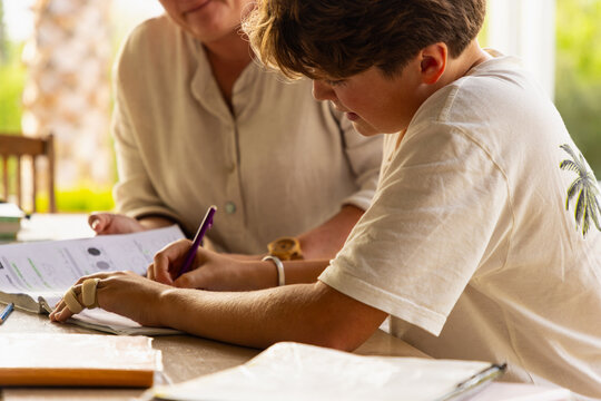 teen age boy being tutored outdoors 