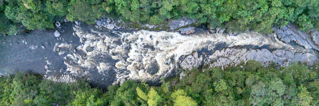 Aerial view of the Estrecho del Rio Magdalena, a narrow rocky gorge with rushing river water surrounded by lush green forest in San Agustin, Huila, Colombia.