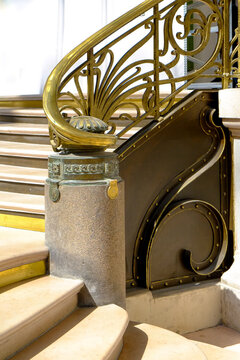 Ornate art nouveau brass and marble banister post detail