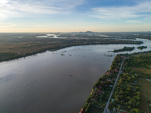 Aerial view of Don Khong island surrounded by the Mekong River with lush vegetation and riverbank settlements in Khong, Champasak Province, Laos.