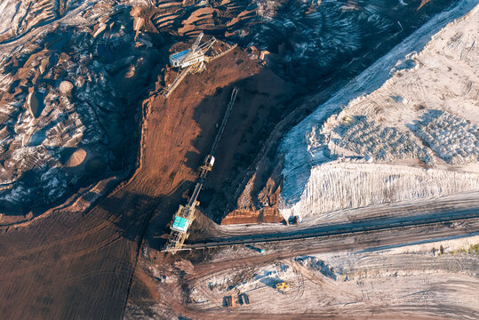 Aerial view of an open-pit lignite mine with large excavators, conveyor belts, and deep earth excavations in Leipzig, Saxony, Germany.