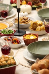 Happy Thanksgiving day. Festive dinner with delicious food and wine on table indoors, closeup