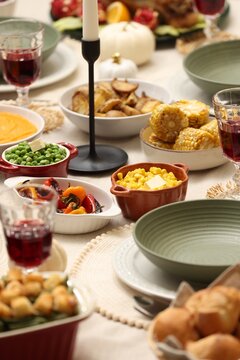 Happy Thanksgiving day. Festive dinner with delicious food and wine on table indoors, closeup