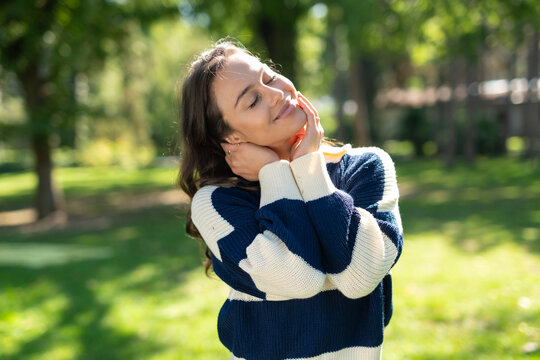Young woman enjoying sunshine with closed eyes in nature