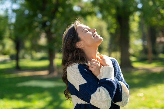 Woman enjoying sunlight in nature feeling peace and joy