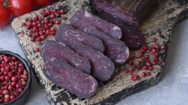 Sliced dry cured beef sausage or basturma with salt and spices. Sliced basturma