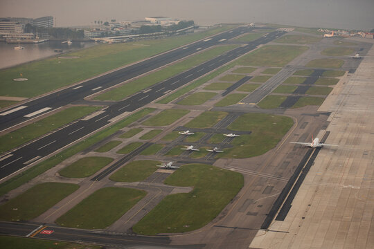 Aerial view of Santos Dumont Airport with runways, taxiways, and parked aircraft situated along the waterfront in Rio de Janeiro, Rio de Janeiro, Brazil.